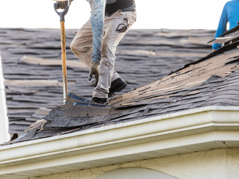 Two workers working on roof repair